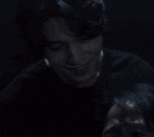 a close up of a man 's face in the dark .