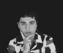 a man with a ring on his finger is looking at the camera