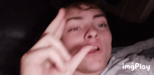 a close up of a person 's face with the words imgplay in the corner