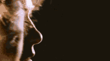 a close up of a woman 's neck and shoulder in a blurry photo .