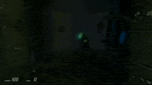 a video game character is standing in a dark room with a green light coming out of his head .