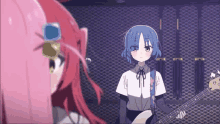two anime girls are standing next to each other and one of them is playing a guitar .