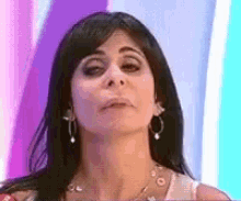 a close up of a woman 's face with a purple background