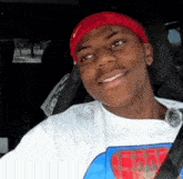a young man wearing a red hat and a t-shirt that says spiderman