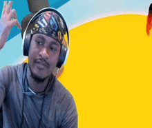 a man wearing headphones and a headband with a picture of cars on it