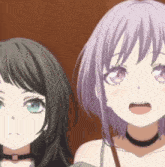 two anime girls are standing next to each other and looking at the camera .