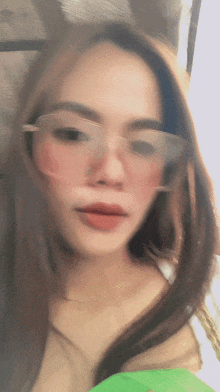 a blurry picture of a woman wearing pink sunglasses