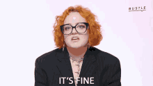 a woman with red hair and glasses making a face and the words it 's fine behind her