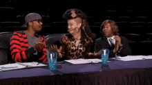 a group of people sitting at a table with i 'm getting goosies written on it