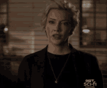 a woman wearing a black shirt and a necklace with a ctv sci-fi channel logo