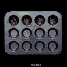 a tray of cupcakes with the word mr.cakes on the bottom right