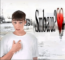 a young boy stands in front of a sign that says smbau ?