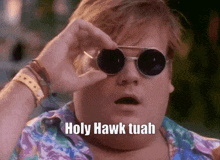 a fat man wearing round sunglasses says holy hawk tuah