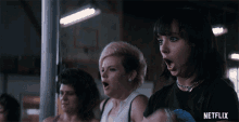 a group of women with their mouths open and a netflix logo behind them