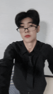 a man wearing glasses and a black shirt
