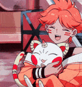 a girl with red hair is holding a cat with a horn