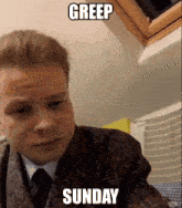 a man in a suit and tie with the words greep sunday written on his face