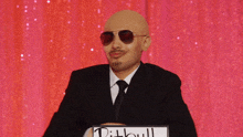 a man in a suit and tie is holding a sign that says pit bull