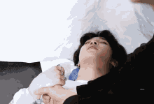 a close up of a person laying on a bed with a white background