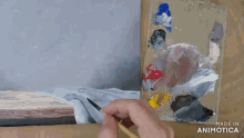 a painting is being painted on a canvas and the words made in animatica are visible
