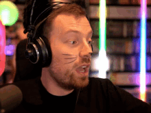 a man wearing headphones and a cat face painted on his face
