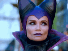 a woman wearing a purple hat with horns on it