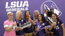 a group of girls are posing for a picture in front of a sign that says i.s.u.a. generals