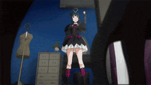 a girl in a black dress is standing in a room