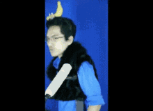 a man with a banana on his head is wearing gloves and making a funny face