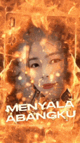a woman 's face is surrounded by flames and the words menyala abangku