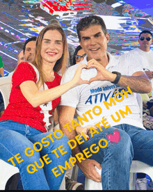 a man and a woman are making a heart shape with their hands while wearing shirts that say modo anivers