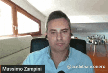 a man in a blue shirt with the name massimo zampina