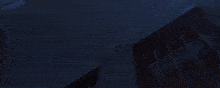 a person is standing in a dark room with a light coming out of the corner .