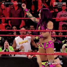 a woman in a wrestling ring with the words sky sports arena live on the screen