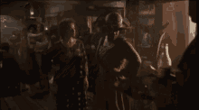 a man in a cowboy hat is standing next to a woman in a dress