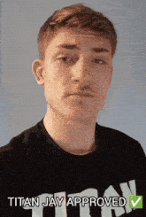 a man wearing a black shirt with the word titan on it