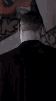 a man with a skull face paint and blood on his shirt