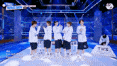 a group of young men are standing on a stage in front of a sign that says tws on it