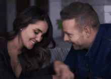 a man and a woman are looking at each other
