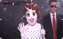 a man in a suit and tie stands next to a woman in a polka dot dress