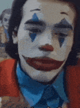 a close up of a person dressed as a clown with a blue eye