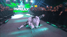 a wrestler named will osprey is laying on the floor
