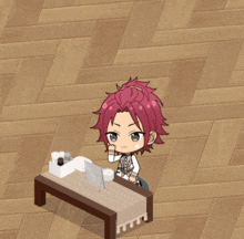 a boy with red hair is sitting at a small table