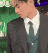 a close up of a man in a suit and tie .