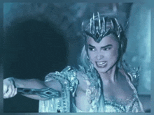 a woman with a crown on her head is holding a sword in her hand