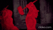 a video of a man holding a rifle with the words clideo.com at the bottom of the screen