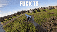 a person holding a gun in a field with the words fuck ts above them