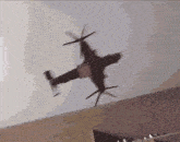 a helicopter is flying over a room with a ceiling in the background