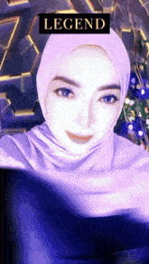 a woman is wearing a purple hijab and the word legend is above her head