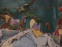 a stuffed cat in a hat is laying on a bed